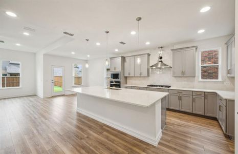 Airy kitchen with oversized island *real home pictured