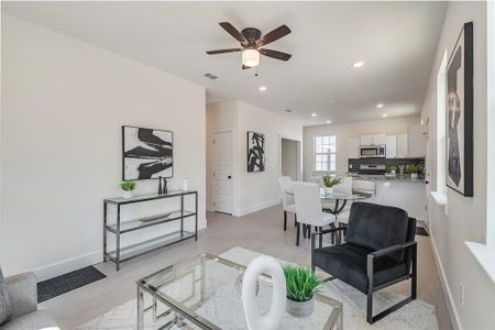 Living room with ceiling fan and light hardwood / wood-style floors