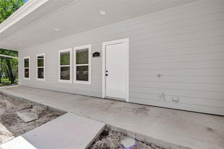 Doorway to property with a patio area