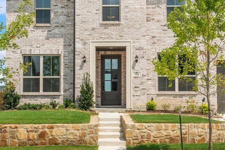 View of exterior entry with a yard