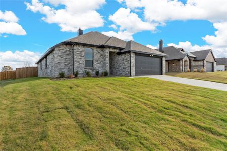 View of front of home with a front yard and a garage