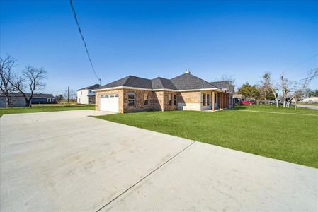 Ranch-style house with a front yard and a garage