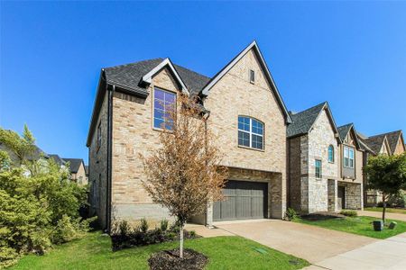 View of front of property with a garage and a front yard