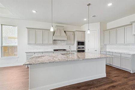 Kitchen featuring decorative backsplash, sink, stainless steel appliances, and dark hardwood / wood-style flooring