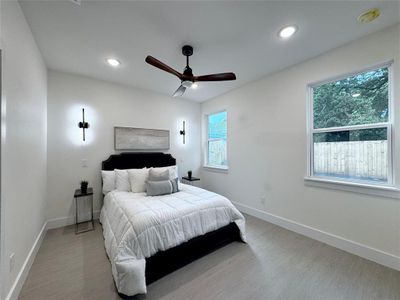 Bedroom with light wood-type flooring and ceiling fan