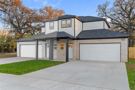 View of front of property with a front yard and a garage