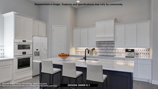 Kitchen featuring a towering ceiling, hardwood / wood-style flooring, an island with sink, white appliances, and sink