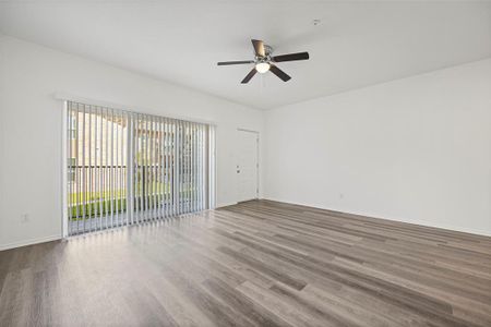 Featuring wood-like flooring and ceiling fan