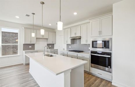 Bright kitchen with oversized island *real home pictured