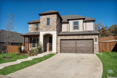 View of front of property with a garage and a front lawn