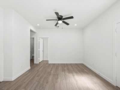 Spacious and open, featuring a ceiling fan and recessed lighting.