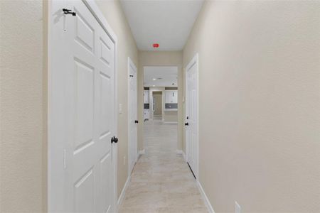 Corridor with light tile patterned floors