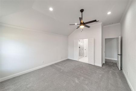 Primary Unfurnished bedroom featuring recessed lighting, carpet floors, baseboards, vaulted ceiling, and crown molding