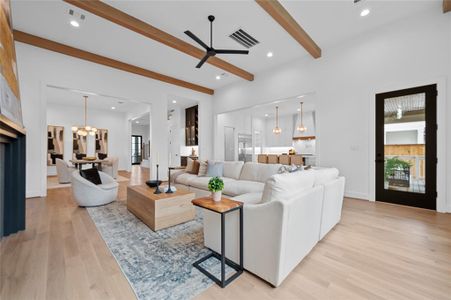 Open floor plan with huge great room with 13' ceiling and white oak wood beam ceiling detail open to dining room and kitchen overlooking backyard