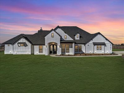 Modern inspired farmhouse featuring french doors and a lawn