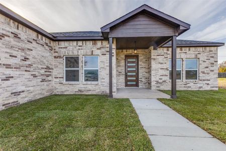 Entrance to property with a lawn