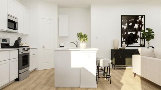 Kitchen with a kitchen island with sink, white cabinetry, stainless steel appliances, sink, and light hardwood / wood-style floors