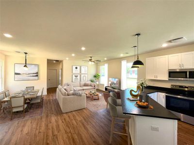 Kitchen featuring ceiling fan, a kitchen breakfast bar, dark wood-type flooring, white cabinetry, and stainless steel appliances