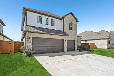 The striking combination of brick and siding creates a sophisticated facade, while the three-car garage offers ample space for vehicles and storage.