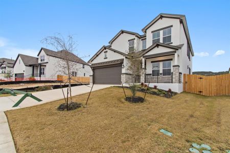 View of front of home with a front lawn and a garage