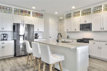 Kitchen with custom cabinetry and island seating.