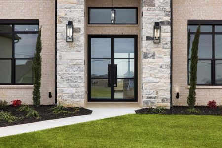 Property entrance featuring french doors and a yard