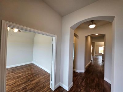 Impressive entry with architectural arches, rotunda, and rich haedwood floors.