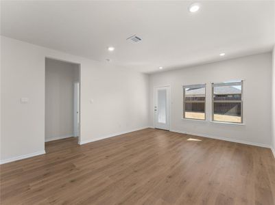 Empty room with hardwood / wood-style flooring