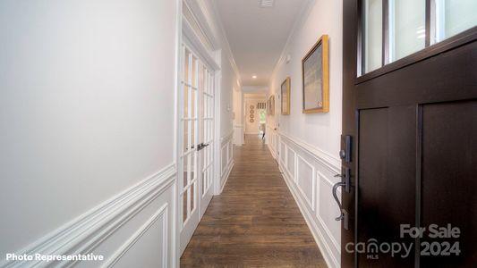 Beautifully trimmed both with wainscotting and crown molding as you enter the foyer.