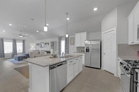 Open Concept Kitchen and Living Area; Featuring View of High Ceilings, Huge Granite Countertop, and Walk-in Pantry