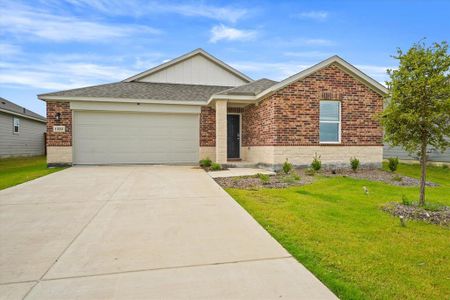 Ranch-style house featuring a garage and a front lawn