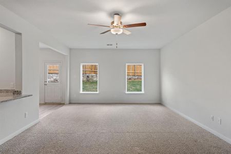 Living room with light carpet and ceiling fan