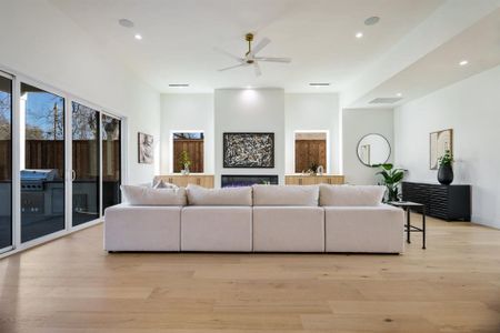 Living room featuring ceiling fan and light hardwood / wood-style floors