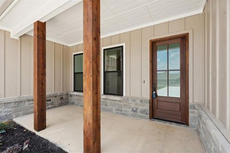 View of entrance to property and covered patio