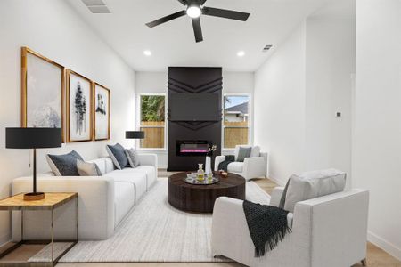 Living room with light hardwood / wood-style floors and ceiling fan