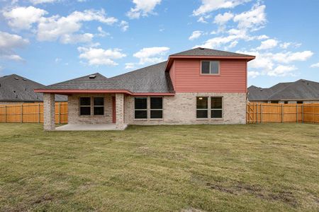 Back of house featuring a patio area and a lawn