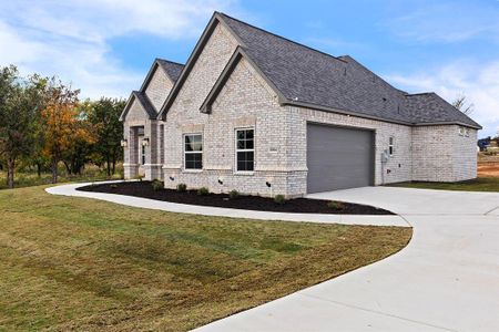 View of side of property with a garage and a yard