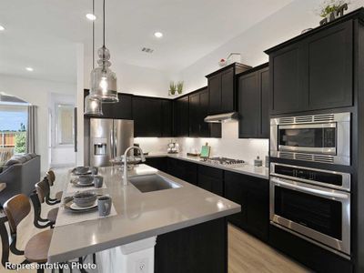 Kitchen featuring a kitchen island with sink, sink, a breakfast bar area, light hardwood / wood-style floors, and stainless steel appliances