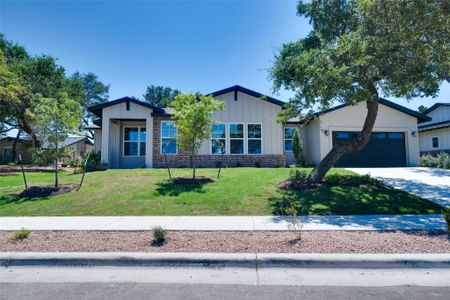 View of front of home with a garage and a front lawn