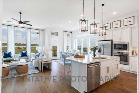 Kitchen with appliances with stainless steel finishes, open floor plan, white cabinetry, and dark wood finished floors