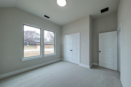 Unfurnished bedroom featuring light carpet and a closet