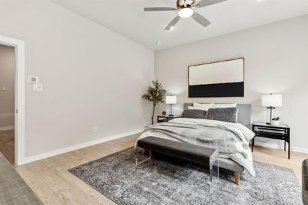 Bedroom with ceiling fan and hardwood / wood-style floors