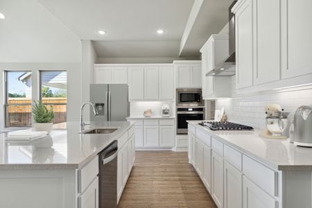 Kitchen in the Morrison home plan by Trophy Signature Homes – REPRESENTATIVE PHOTO