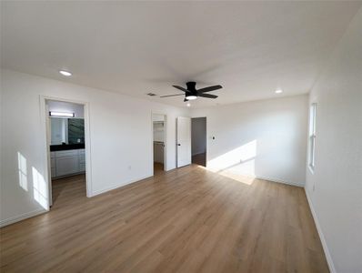 Spare room with ceiling fan, light hardwood / wood-style floors, and plenty of natural light