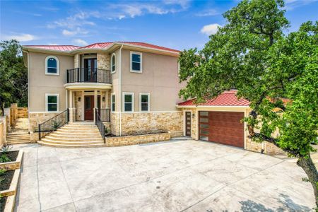 View of front facade with a balcony and a garage