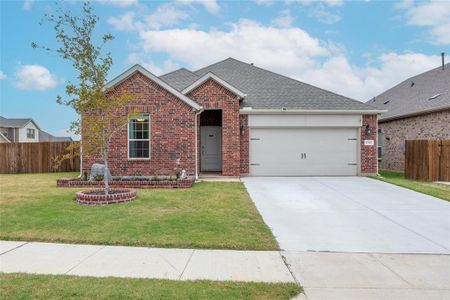 View of front of house featuring a front yard and a garage