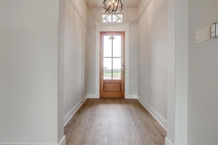 Entryway featuring a notable chandelier and light hardwood / wood-style flooring