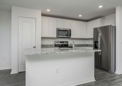 The kitchen is chef-ready with stainless steel appliances