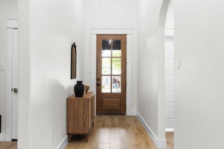 Doorway featuring light wood-type flooring