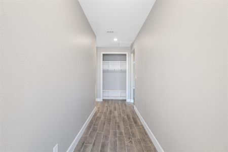 Corridor featuring wood-type flooring